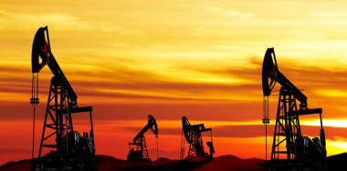Oil pumps silhouette at colorful sunset clipart