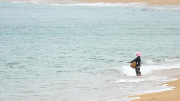 Uma mulher pega um peixe na fiação — Vídeo de Stock