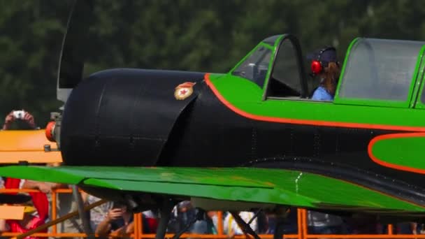 Летчик спортивного самолета ЯК-52 поздравляет зрителей авиасалона — стоковое видео