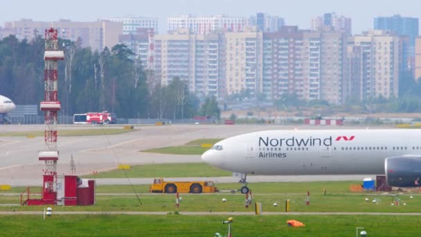 Boeing 777 avião sendo rebocado por caminhão rebocador para a partida — Vídeo de Stock