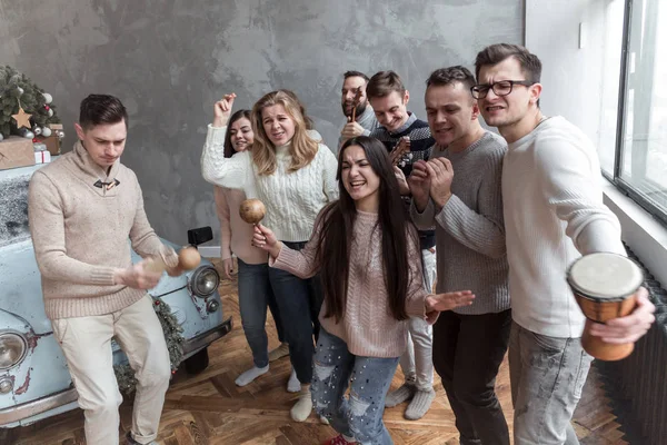 Funny Young People Sing a Song and Dance. Christmas concept