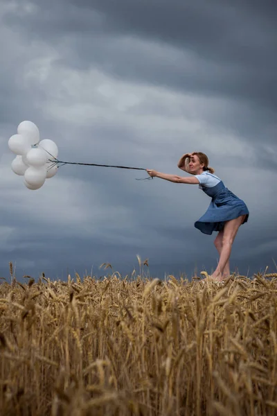 Křehká žena udržuje pozice proti silnému větru — Stock fotografie