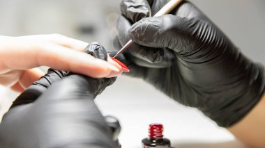 The process of creating the perfect red manicure. Women's Concept. Beauty.