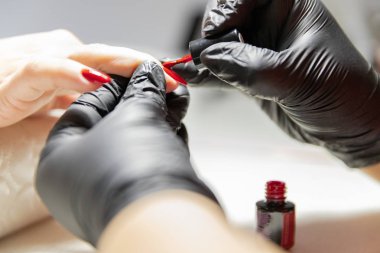 The process of creating the perfect red manicure. Women's Concept. Beauty.