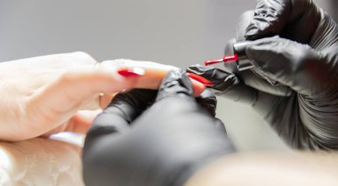 The process of creating the perfect red manicure. Women's Concept. Beauty.