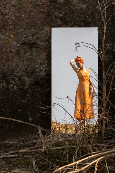 Oriental mulher em brocado vestido refletido em um espelho fora do deslocamento . — Fotografia de Stock