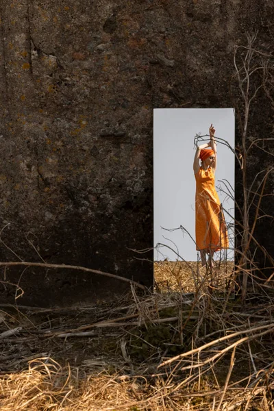 Oriental mulher em brocado vestido refletido em um espelho fora do deslocamento . — Fotografia de Stock