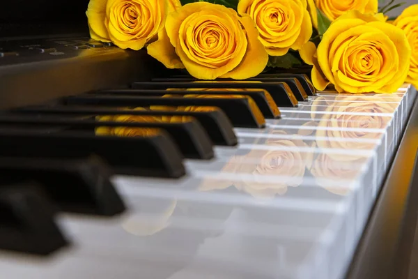 A bouquet of yellow roses on the piano. Musical Concept. Background. Copy Space Royalty Free Stock Images