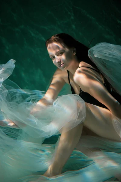 Jeune fille mince sous l'eau avec un chiffon. Magie de l'eau. Photographie sous-marine. L'art — Photo