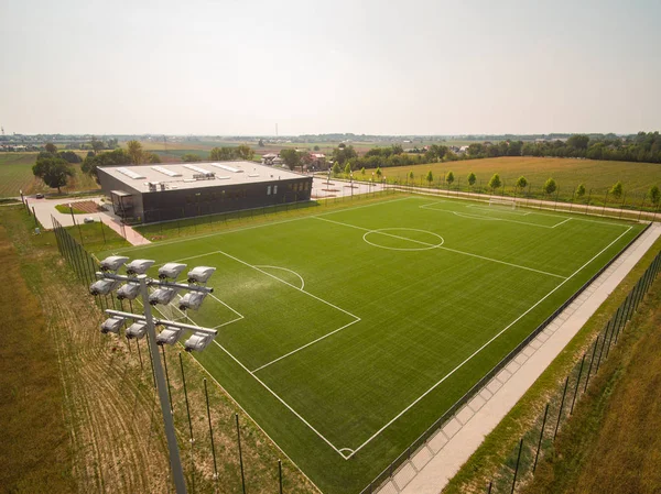 football field with light stand and lighting