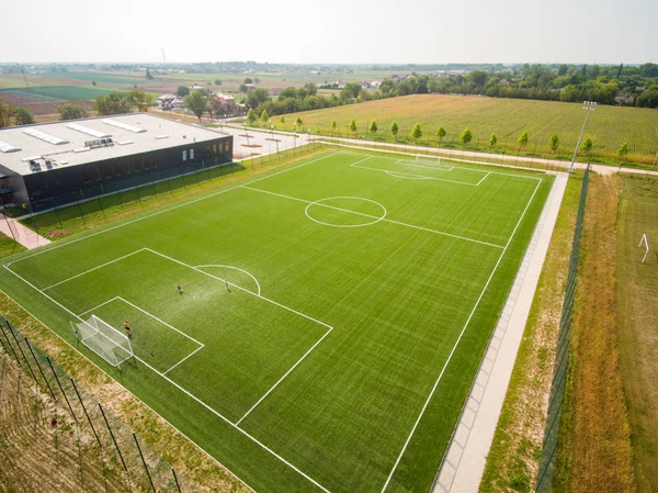 football field with light stand and lighting