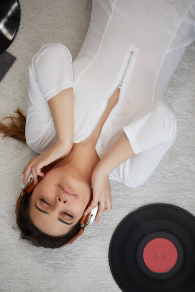 the image of resting sexy woman listening to vinyl