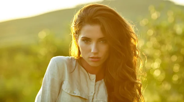 Portrait of young beautiful woman in sunset light