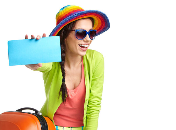 portrait of female tourist with travel suitcase and boarding pass