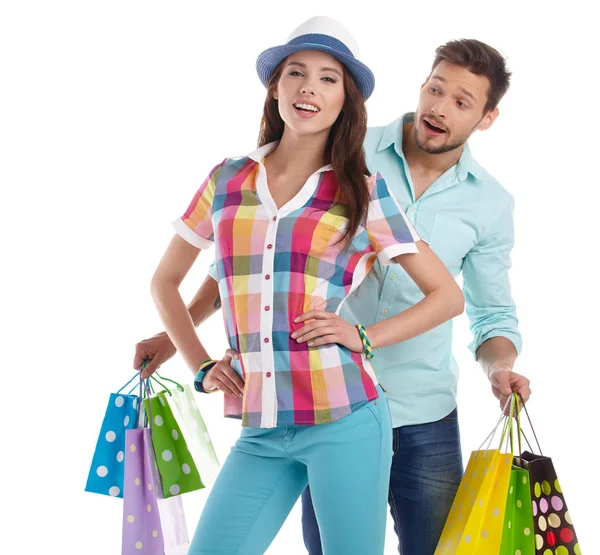 Atractiva pareja joven sosteniendo bolsas de compras sobre fondo blanco — Foto de Stock