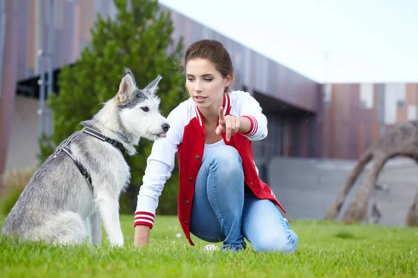 女性は彼女の犬は屋外で遊ぶ — ストック写真