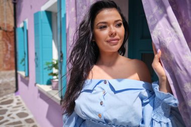 Burano adasında renkli evler arasında poz turist kadın, Venedik. İtalya'da turizm konsepti 
