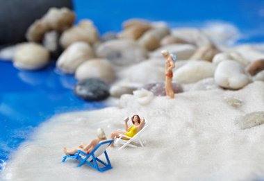 Bir güverte sandalyede rahatlatıcı bir minyatür çift arka görünümü 