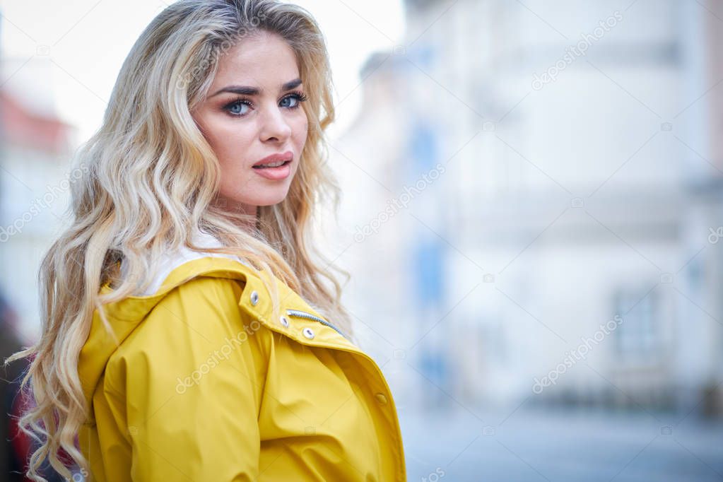The girl in the yellow coat on the street, stylish outfit, woman