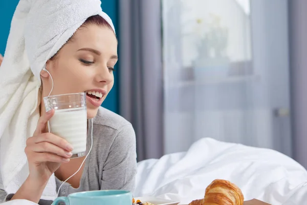 Mädchen mit Handtuch auf dem Kopf frühstückt im Bett — Stockfoto