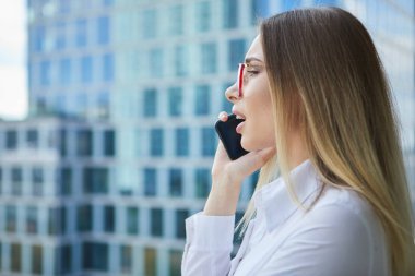 Th arka planda akıllı telefon ile güzel iş kadını