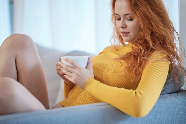 Hermosa mujer bebiendo un café sentada en su casa cama — Foto de Stock