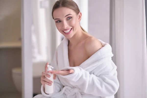 Young woman with flawless skin, applying moisturizing cream on h — Stock Photo, Image