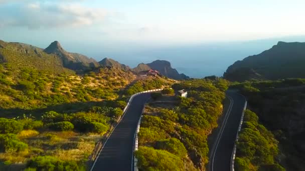 Vista da altura das rochas, estrada sinuosa e oceano na distância na Masca ao pôr do sol, Tenerife, Ilhas Canárias, Espanha . — Vídeo de Stock