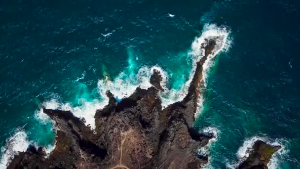 Egy elhagyatott part első látásra. Tenerife szigetének sziklás partja. Légi felvételek a partot elérő tengeri hullámokról — Stock videók