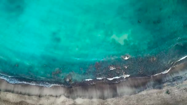 Vista superior de una playa volcánica negra desierta. Costa de la isla de Tenerife. Imágenes aéreas de drones de olas marinas que llegan a la orilla — Vídeo de stock