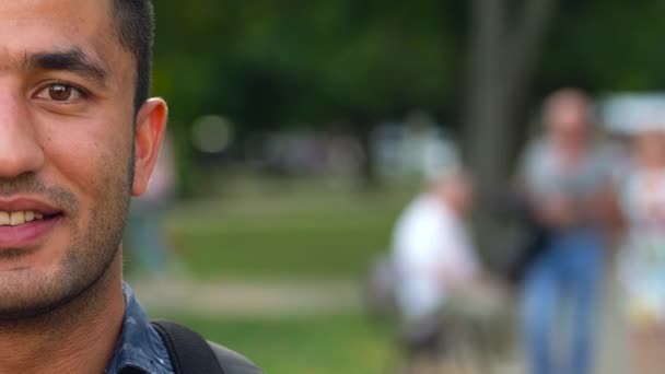 Portrait of a young Arab smiling man. Half face — Stock Video