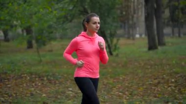 Bir sonbahar parktan günbatımında çalışan kadın. Kilo vermek için karar verdim kadın