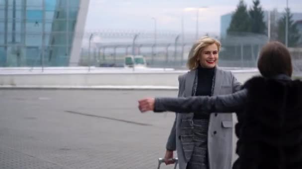 Langersehntes Treffen zweier Freunde am Flughafen — Stockvideo