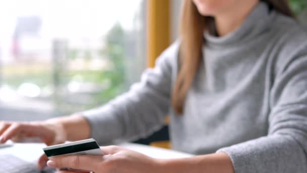 Woman makes online payment at home with a credit card and laptop — Stock Video