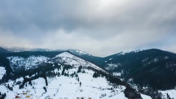 Hyper verval van zware onweerslucht waarop de hemel over landschap van besneeuwde bergen en naaldbossen bos op de hellingen — Stockvideo