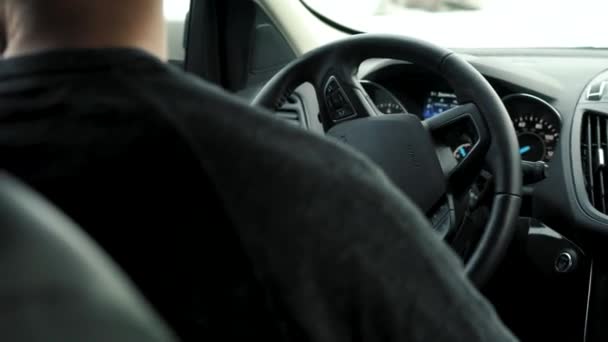 Man rijdt auto via een parkeerplaats en is op zoek naar een park of rijden — Stockvideo
