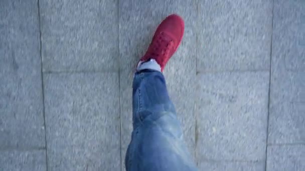 Top view of mens legs in red sneakers walking along the trowalk — стоковое видео