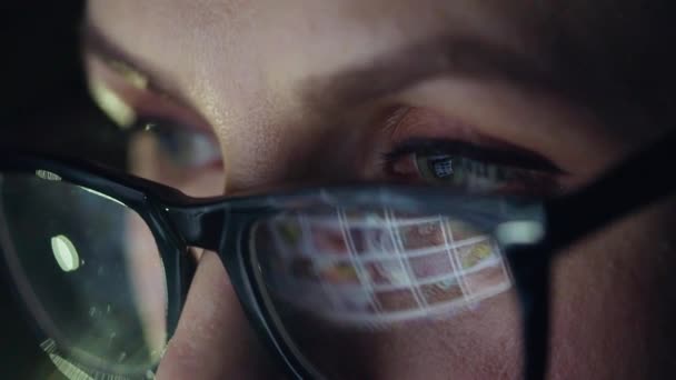 Femme en lunettes regardant sur le moniteur et surfer sur Internet. L'écran du moniteur est réfléchi dans les lunettes — Video