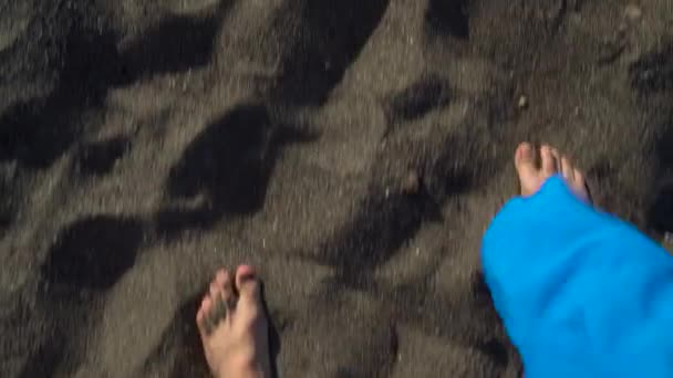 Top view of couple strolling together at the black volcanic sand at ocean beach — Stock Video