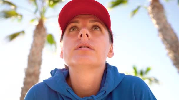 Woman stops while jogging to check the data in the smart watch application, rests and continues to run — Stock Video