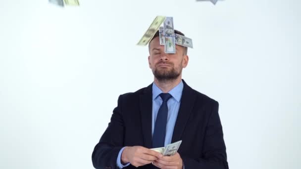 Slow motion of formally dressed man scatters money, and a lot of dollar bills are fall on him — Stock Video