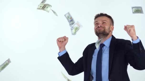 Slow motion of formally dressed man is delighted with the fact that a lot of dollar bills are fall on him — Stock Video