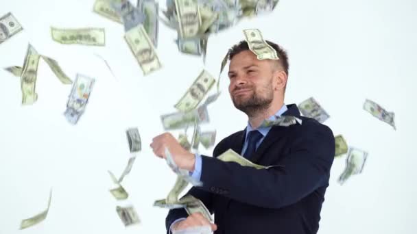 Slow motion of formally dressed man performs a victory dance, and a lot of dollar bills are fall on him — Stock Video