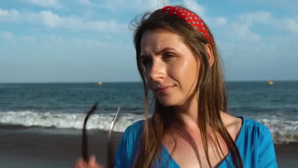 Portrait of a woman in a beautiful blue dress on a black volcanic beach — Stock Video