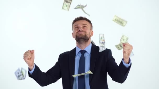 Slow motion of formally dressed man is delighted with the fact that a lot of dollar bills are fall on him — Stock Video