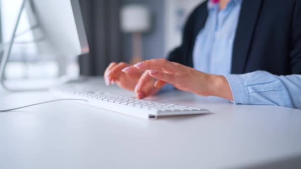 Woman in glasses typing on a computer keyboard. Concept of remote work. — Stock Video