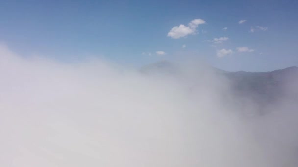 Flying through the clouds over the island of Tenerife - a view of the settlements and the Teide volcano. Canary Islands, Spain — Stock Video