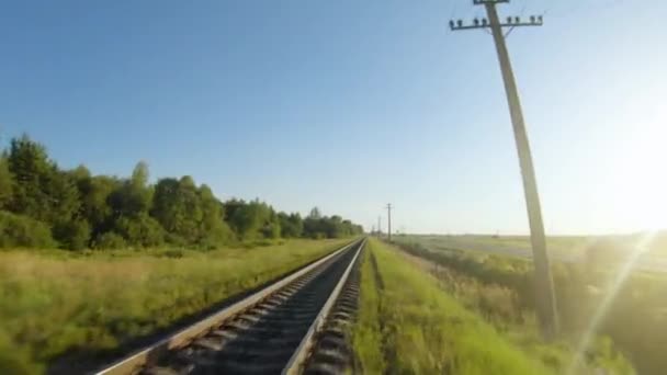 FPV drone flight fast and maneuverable along railway in a clear sunny day — Stock Video