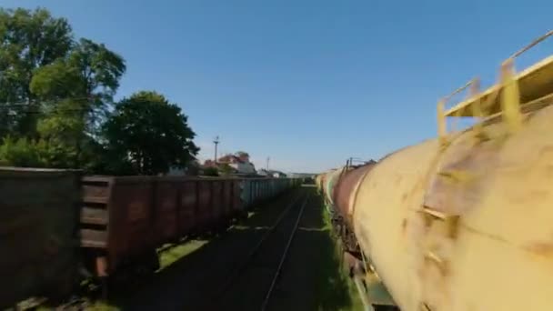 Fast and maneuverable flight along freight carriages. — Stock Video