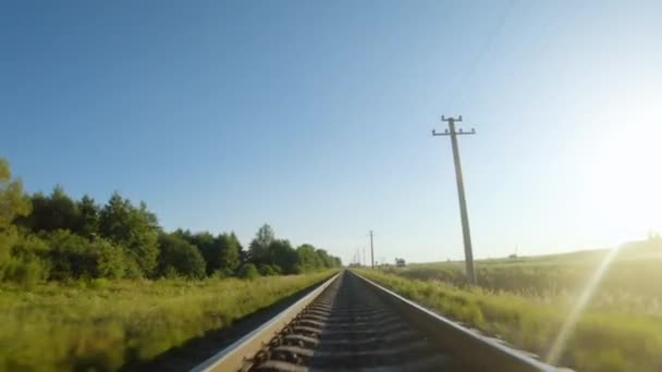 Fast flight close to train tracks in a clear sunny day — Stock Video